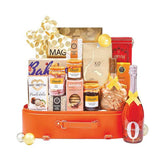 Flower delivery hamper with assorted gourmet treats, sparkling drink, and elegant packaging