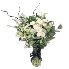 Elegant white flower bouquet in glass vase for flower delivery