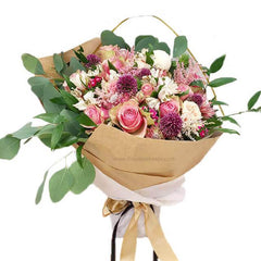 Mixed flower bouquet with pink roses and mums, wrapped for flower delivery