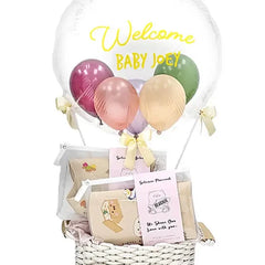 Newborn gift basket with welcome balloon and pastel balloons, suitable for flower delivery