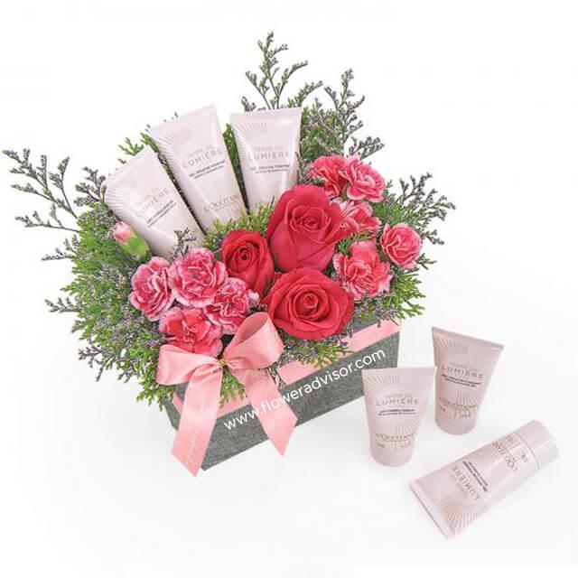 Pink rose and carnation flower delivery gift set with beauty products and pink ribbon