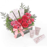 Pink rose and carnation flower delivery gift set with beauty products and pink ribbon