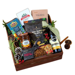 Festive floral hamper with gourmet snacks, pinecones, and decorative greenery, ideal for flower delivery.