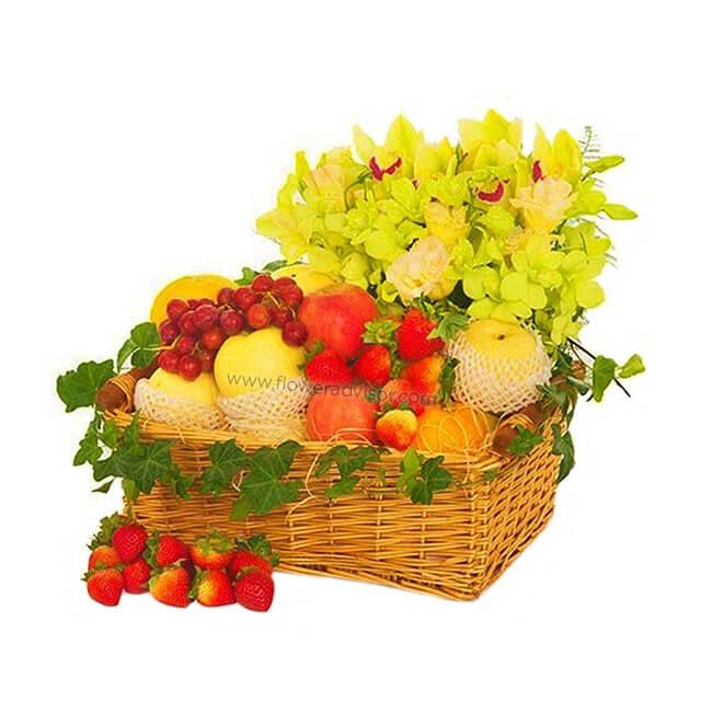 Yellow flower bouquet and fresh fruit hamper in wicker basket for flower delivery