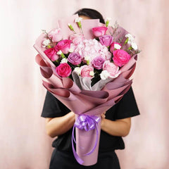 Pink and purple flower bouquet with roses and hydrangeas for flower delivery
