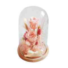 Pink preserved flowers in glass dome for flower delivery, elegant and romantic gift arrangement
