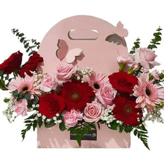 Hand-carry pink and red floral arrangement in a gift box for flower delivery
