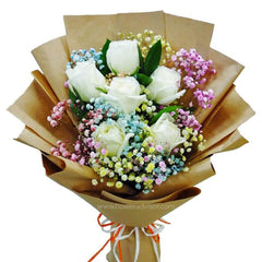 Hand bouquet with six white roses and rainbow baby's breath for flower delivery
