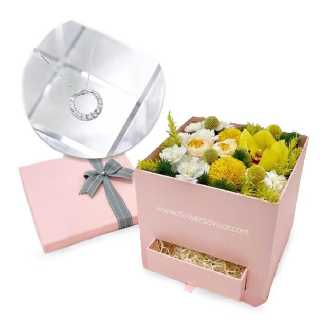 Elegant flower delivery box with fresh yellow and white blooms and a ring pendant necklace gift