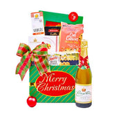 Christmas gift hamper with cookies, sparkling juice, festive treats and ribbon for flower delivery