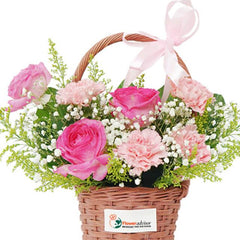 Flower delivery basket with pink roses, carnations, baby’s breath and greenery