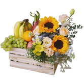 Flower delivery crate with sunflowers, mixed blooms, and assorted fresh fruits