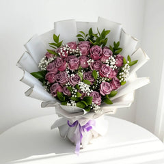 Elegant bouquet of purple roses and baby's breath with greenery, perfect for flower delivery