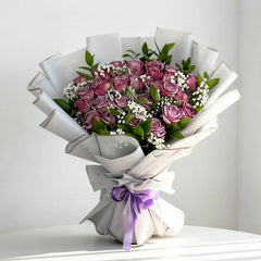 Lavender rose bouquet with baby's breath in white wrapping, ideal for flower delivery gift