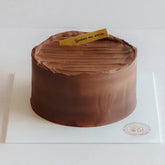 Chocolate cake on white board for cake and flower delivery in Singapore