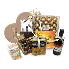 Gift hamper with wine, chocolate, coffee, tea, and snacks for flower delivery occasions