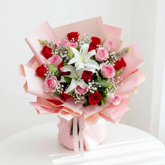 Elegant pink and red rose bouquet with lilies, perfect for flower delivery in Singapore.