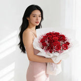 Woman holding romantic red rose bouquet for flower delivery in Singapore