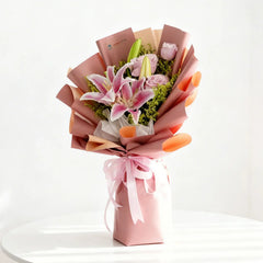 Elegant pink lily and rose bouquet in gift wrap for flower delivery in Singapore