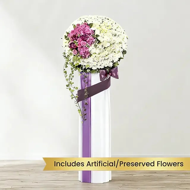 Standing flower arrangement with white and purple blooms, ideal for flower delivery service