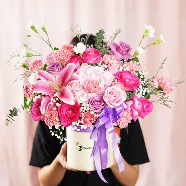 Vibrant pink and purple flower arrangement in a box, ideal for flower delivery in Singapore