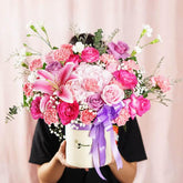 Vibrant pink and purple flower arrangement in a box, ideal for flower delivery in Singapore