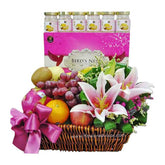 Flower and fruit basket with lilies, assorted fruits, and 6 bottles, ideal for flower delivery
