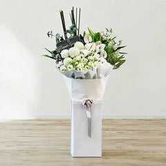 Elegant white flower bouquet with greenery for delivery, ideal for sympathy or special occasions