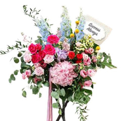 Grand opening flower stand with pink, red, and blue blooms for flower delivery in Singapore