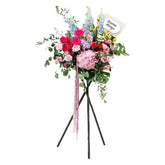 Grand flower stand with pink roses, hydrangeas, and mixed blooms for delivery