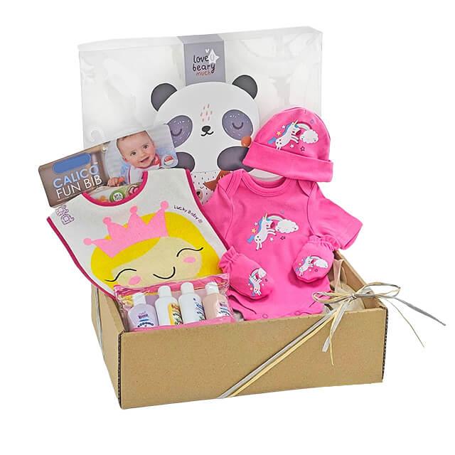 Baby gift box with pink unicorn romper, hat, mittens, cartoon bib, and baby care products