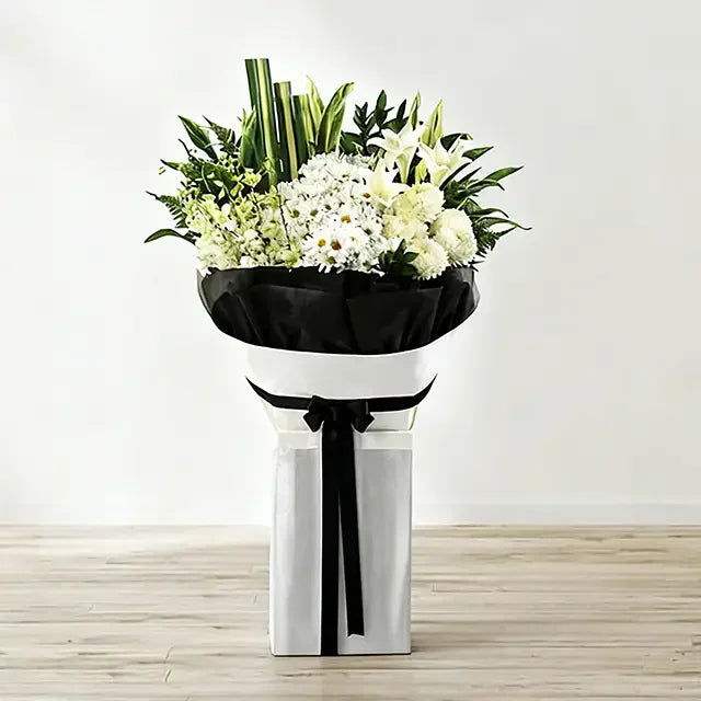 Elegant white flower bouquet with lilies and chrysanthemums, wrapped for delivery in Singapore
