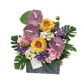 Colorful artificial flower arrangement with anthurium, hydrangea, and roses for delivery