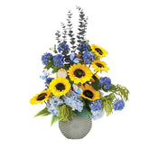 Bright sunflower and blue hydrangea arrangement in vase for flower delivery