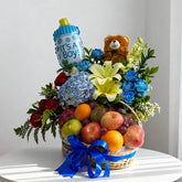 Flower delivery basket with mixed fresh flowers, fruits, teddy bear, and blue ribbon for baby boy