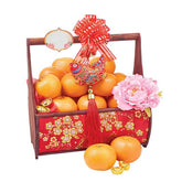 Chinese New Year hamper with fresh oranges, pink peony flower, and festive floral basket for delivery
