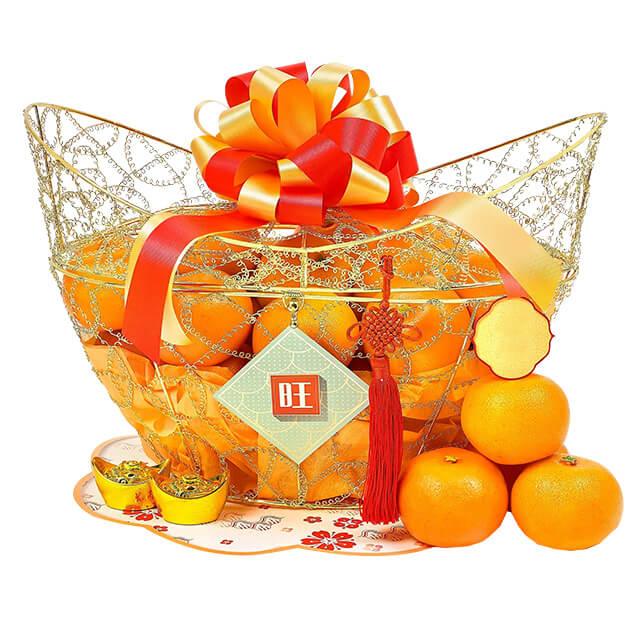 Chinese New Year hamper with fresh oranges, decorative gold basket, ribbon, for flower delivery