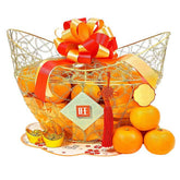 Chinese New Year hamper with fresh oranges, decorative gold basket, ribbon, for flower delivery