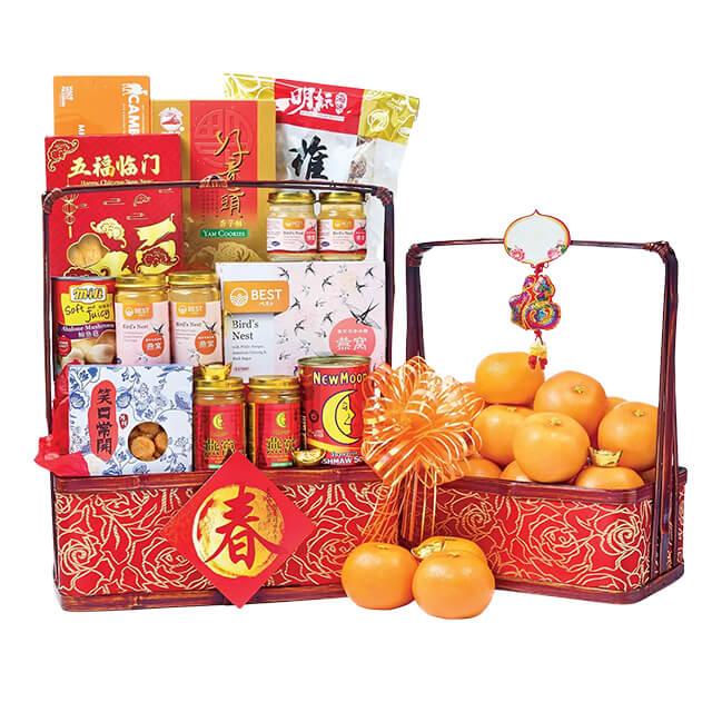Chinese New Year festive hamper with oranges, snacks, and decorative elements for delivery
