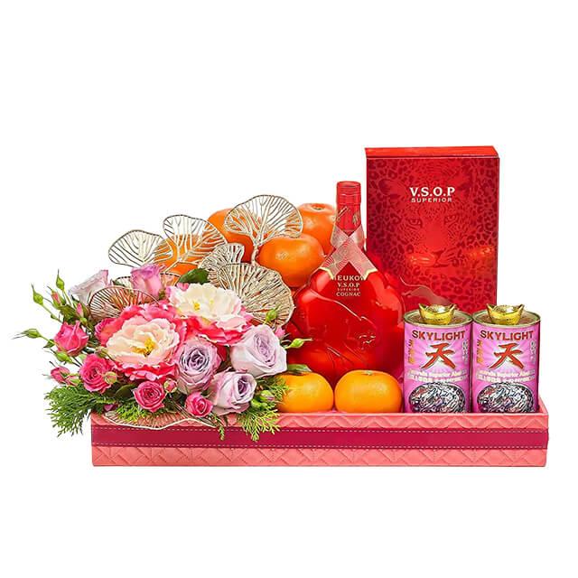 Chinese New Year hamper with fresh flowers, oranges, and festive gifts for flower delivery