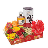 Chinese New Year flower hamper with fresh roses, gift box, oranges and festive decorations for delivery