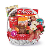 Festive gift basket with fresh flowers, chocolate treats, ideal for flower delivery in Singapore