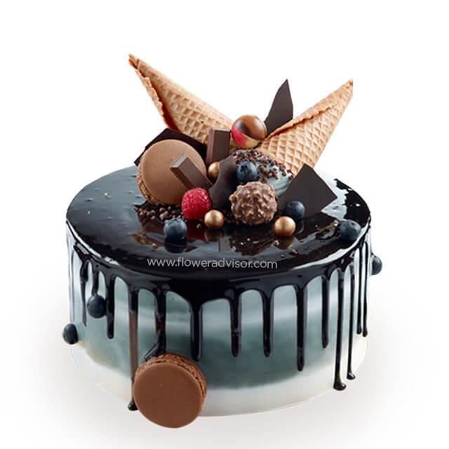 Decadent chocolate drip cake with berries, wafers, and truffles for flower delivery gifts