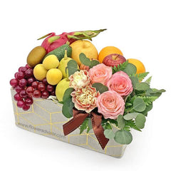 Flower delivery basket with pink roses, carnations, fresh fruits, and greenery arrangement