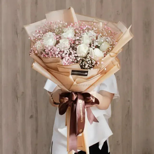 Elegant bouquet of 12 white roses with pink baby's breath for flower delivery