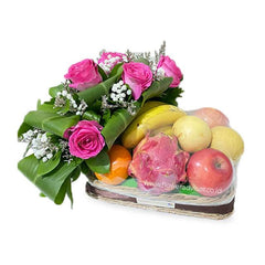 Flower delivery basket with pink roses, green foliage, and assorted fresh fruits