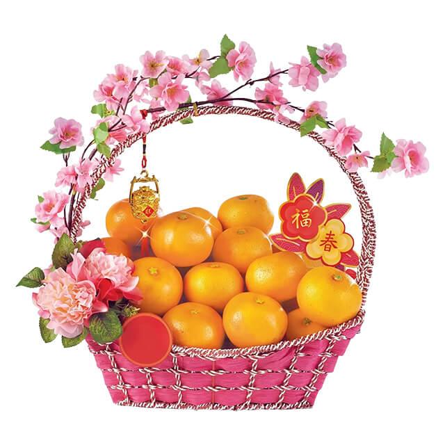 Mandarin orange gift basket with pink flowers for festive flower delivery