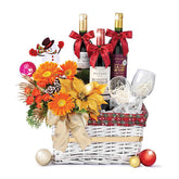 Festive flower delivery basket with bright orange blooms, wine, glasses, and holiday decor