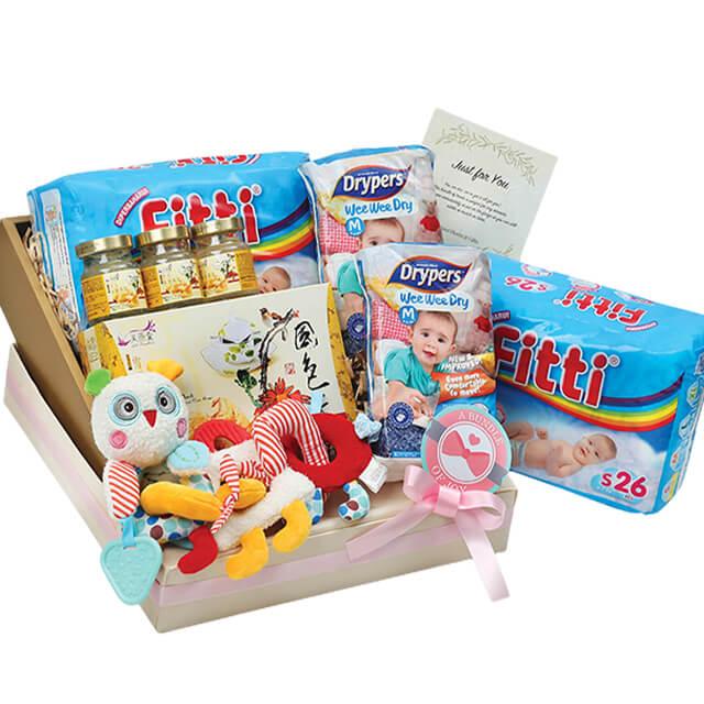 Baby gift hamper with diapers, toys, bird’s nest, and card, perfect for flower delivery in Singapore