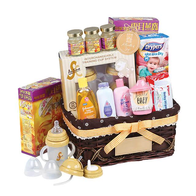 Baby gift hamper with feeding bottles, baby care products, diapers, and floral accents for delivery